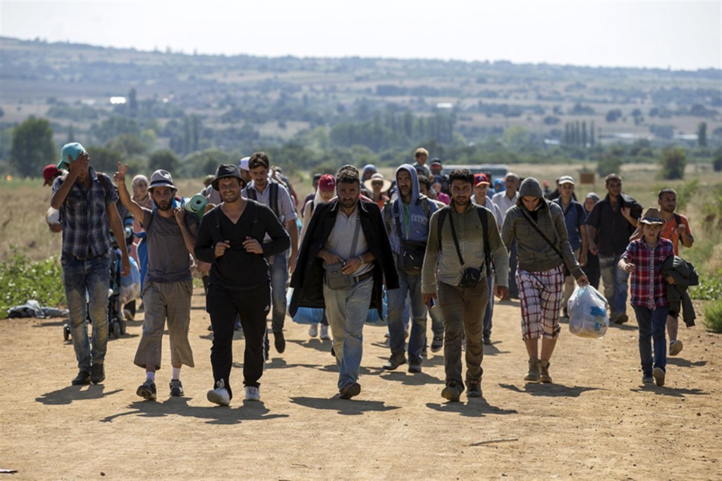 Migrants from Syria walk along a road near the town of Presevo, Serbia Photo credit: Reuters/Marko Djurica