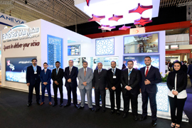 Es'hailSat executives pose in front of the Es'hailSat stand at the IBC in Amsterdam, September 2016. Photograph courtesy of Es'hailSat.