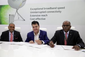 Farhad Khan, Chief Operating Officer of Yahsat (left) and Alan Afrasiab, Founder, President, and Chief Executive Officer of Talia Limited (centre) sign their partnership agreement on 15 November 2016. Photograph courtesy of Talia Limited.